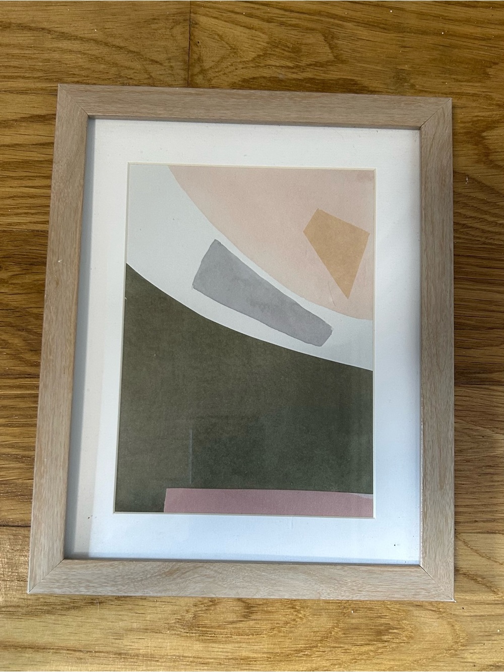 Abstract geometric print w/ beige, gray, and olive green shapes in wooden frame